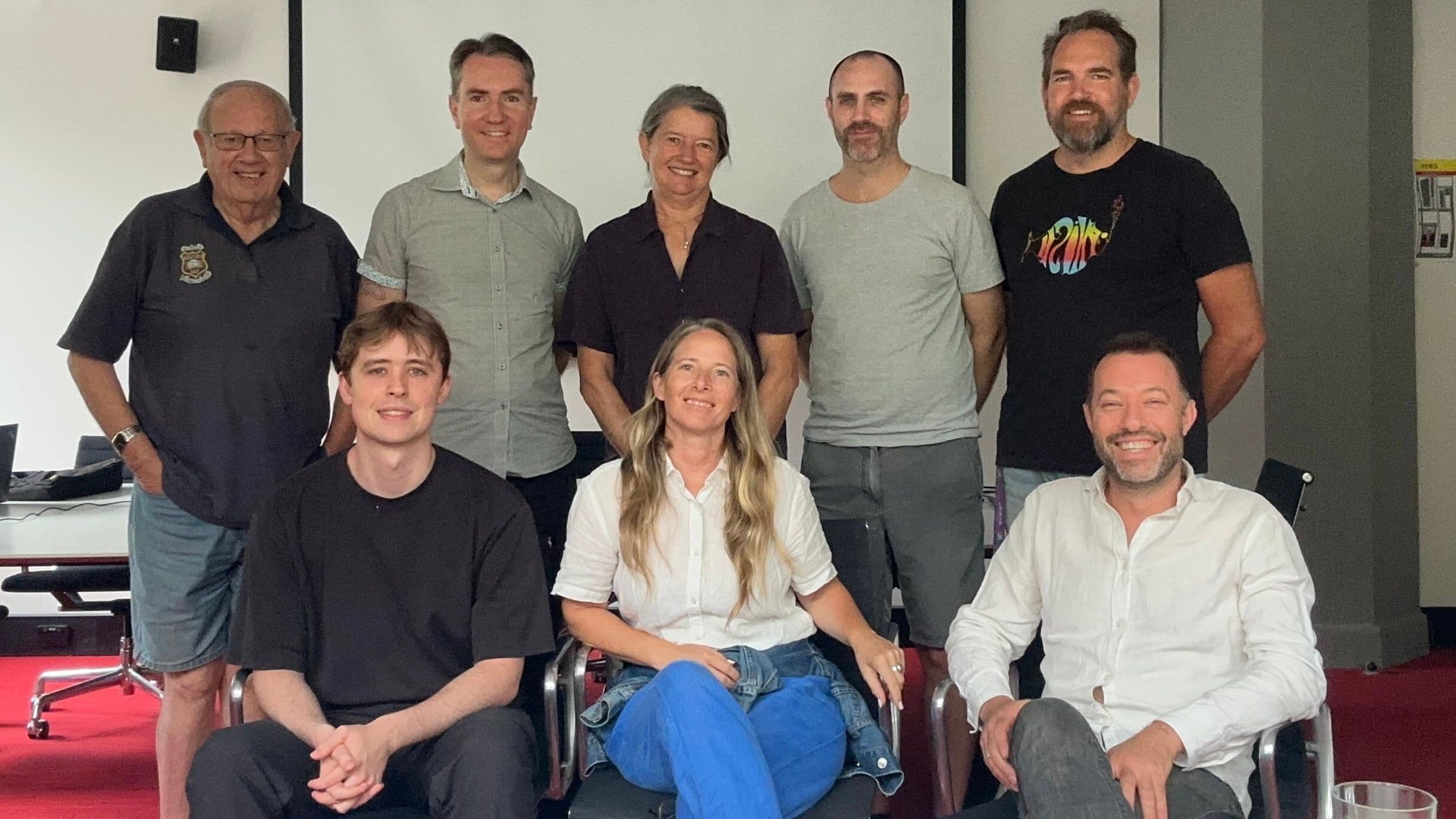 8 Sydney Degrowth members smiling and lined up for a photo