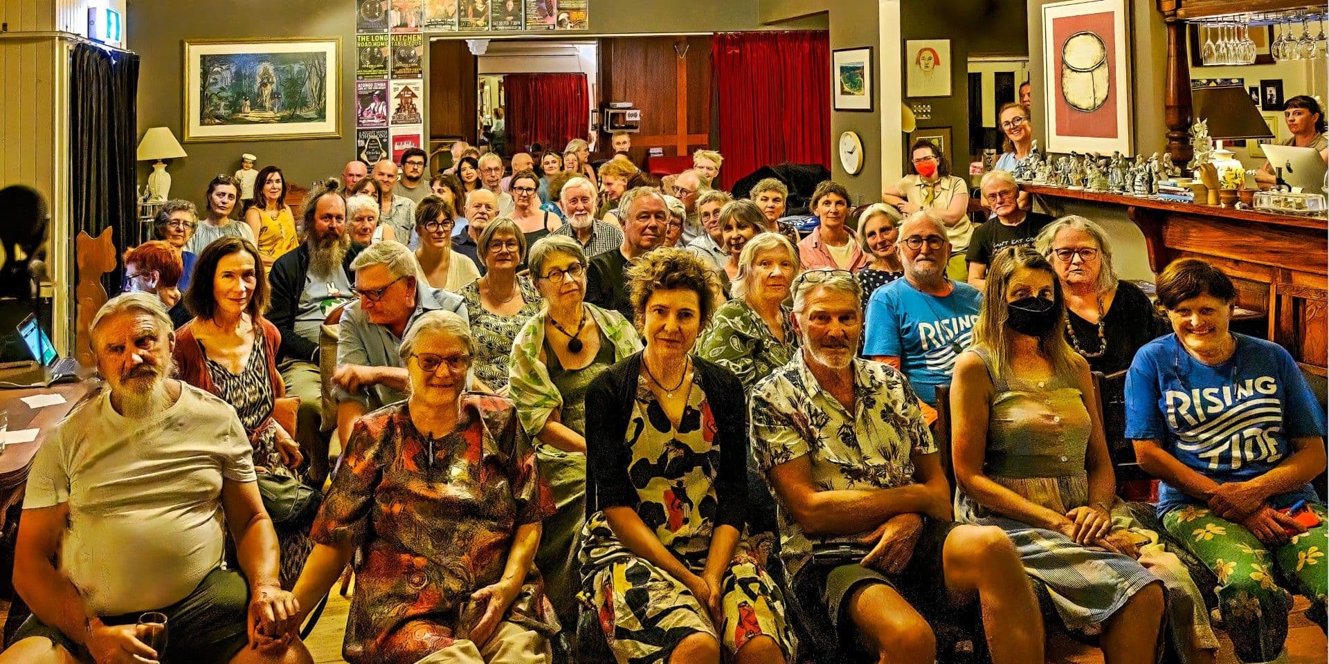 About 50 happy people seated in rows